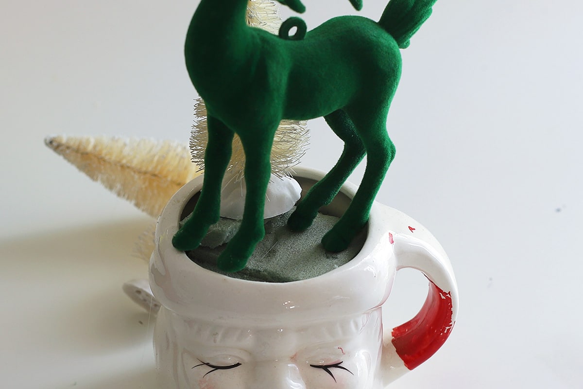 Green flocked deer Christmas tree decoration.