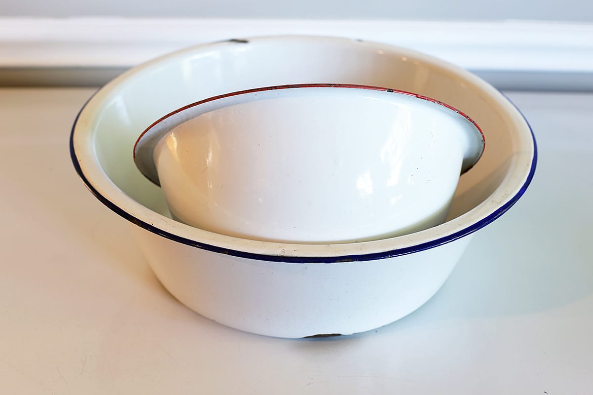 Two enamelware bowls to be used in a solar powered fountain planter project.