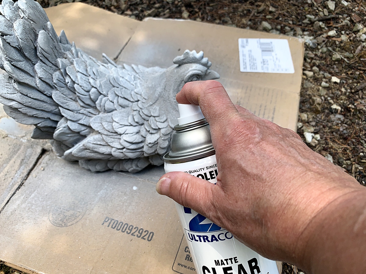 Spraying item with exterior matte clear sealer.