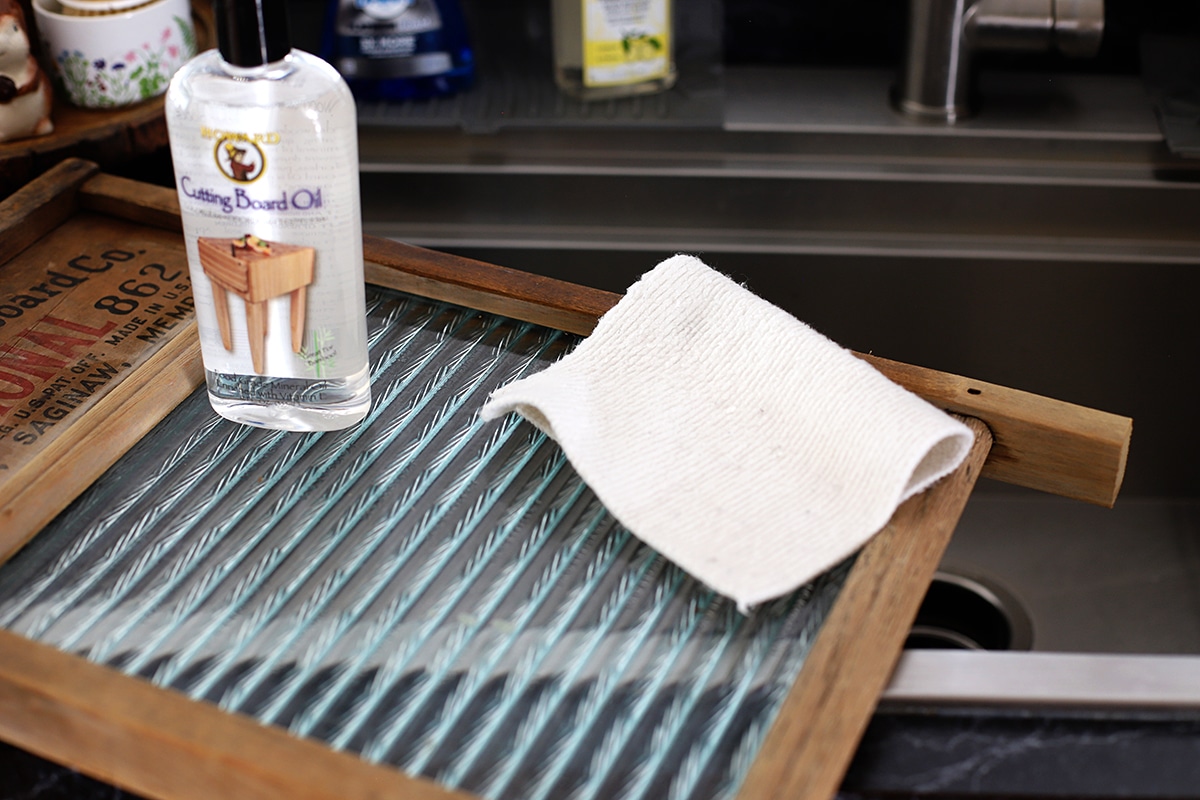 Applying Howard's Cutting Board Oil to an old wooden washboard to hydrate the wood.
