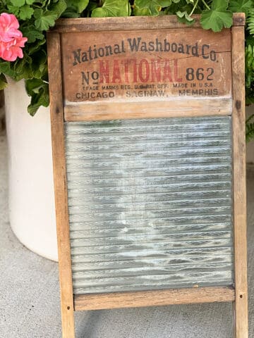 Repurposing a vintage wood and glass washboard into a rustic table centerpiece.