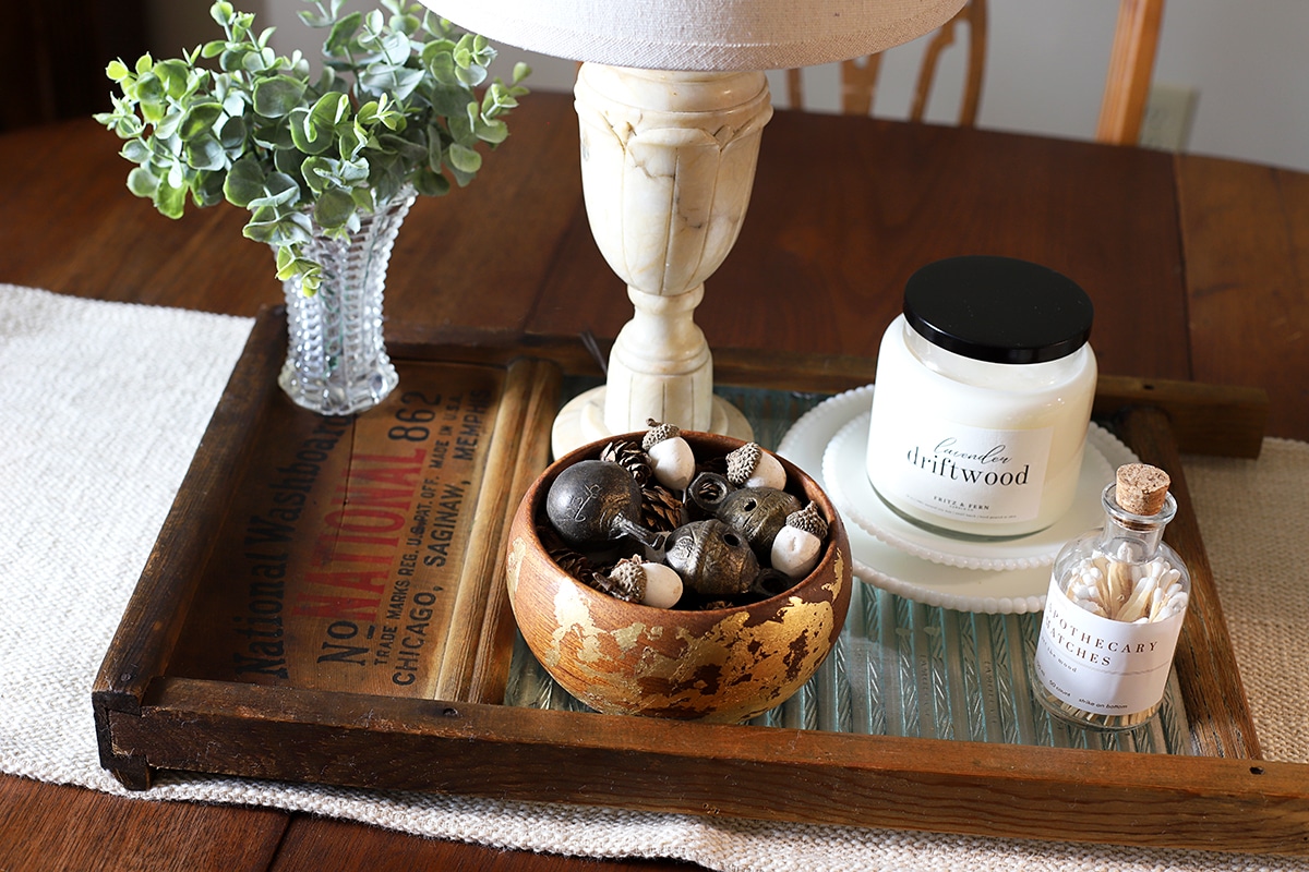 Repurposing a vintage wood and glass washboard into a rustic table centerpiece.