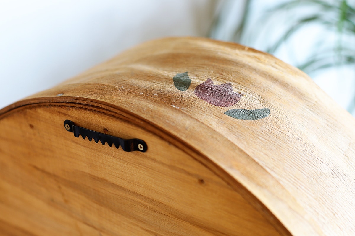 Showing the saw-tooth picture hanger attached to the back of the cheese box. 
