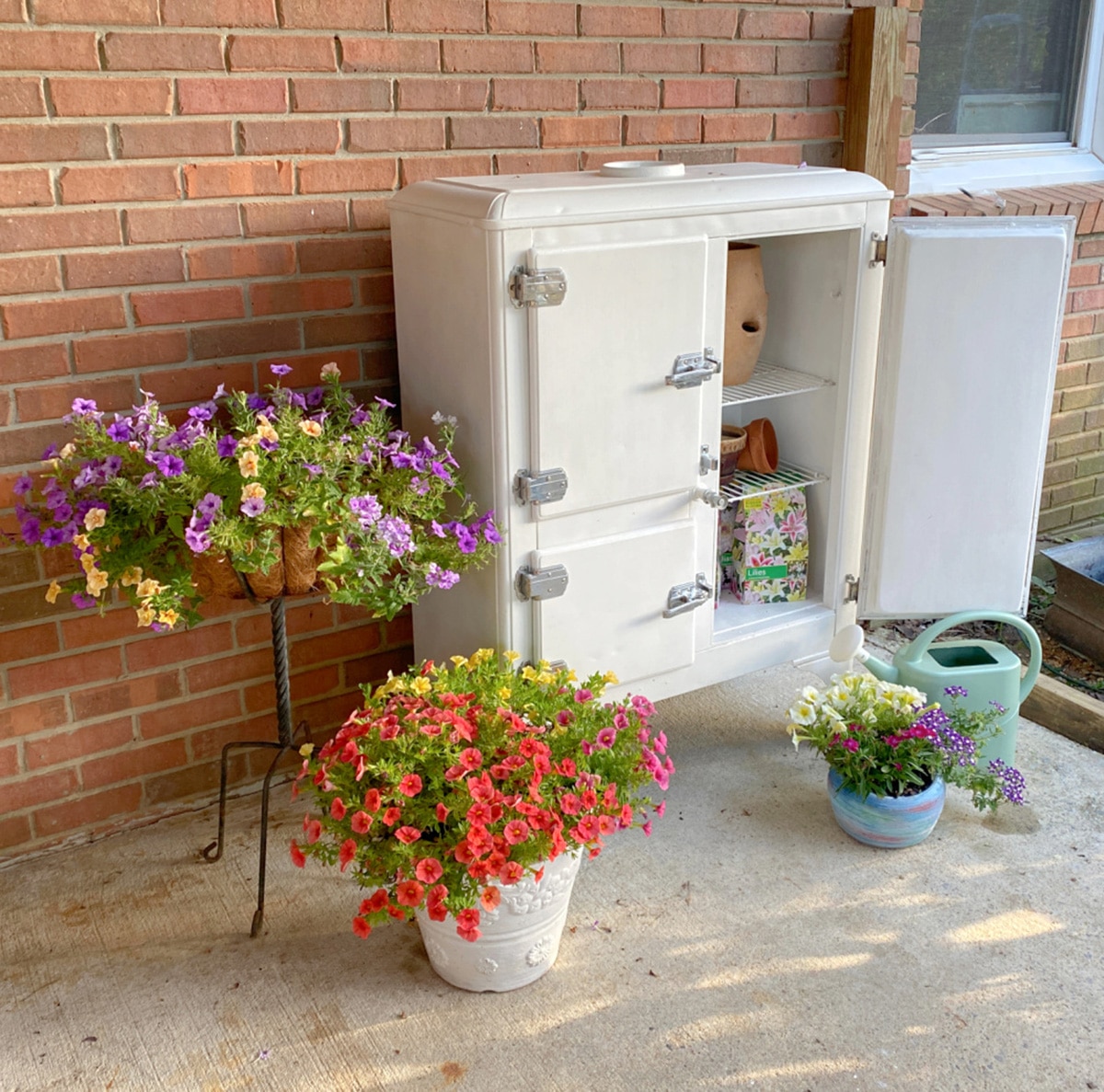 Vintage ice box turned into a gardening storage area.