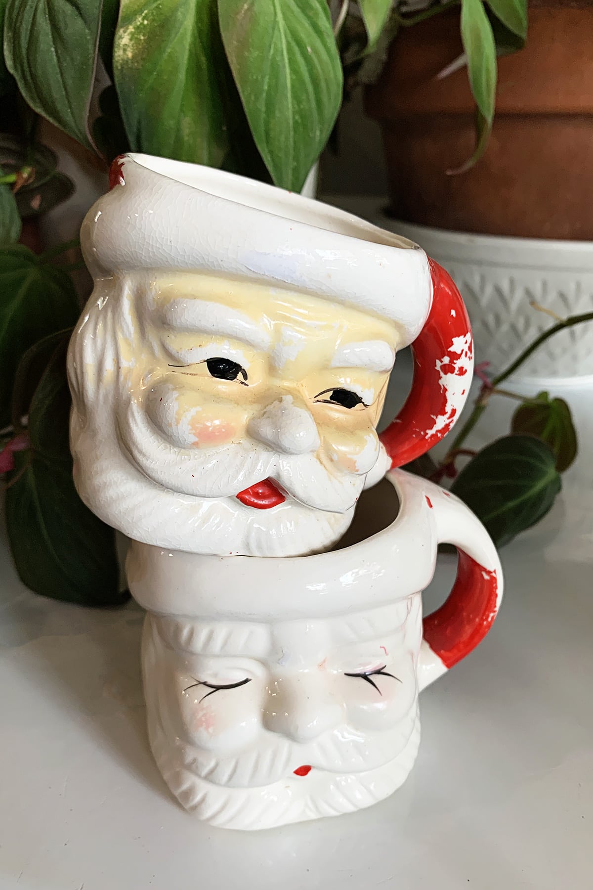 Two vintage Santa mugs stacked on top of each other.